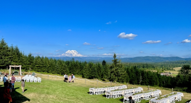 Wide Shot of Back Lawn Showing Wedding Ceremony Set Up and Reception Area with Mt. Rainier in Background