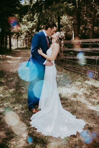 Groom Kissing Bride in Woods